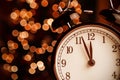Vintage alarm clock is showing midday or midnight. It is twelve o`clock, christmas and bokeh, holiday happy new year festive