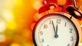 Vintage alarm clock is showing midnight. It is twelve o`clock, christmas and bokeh, holiday happy new year festive concept Royalty Free Stock Photo