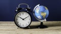 Vintage Alarm Clock and Small World Globe Symbolizing Global Time and Deadlines Royalty Free Stock Photo