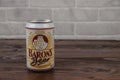 A vintage aluminium can of Barons beer against the brick wall