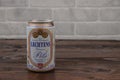 A vintage aluminium can of Lechtens beer against the brick wall