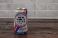 A vintage aluminium can of RWB beer against the brick wall