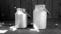 Vintage aluminum milk cans on wooden floor