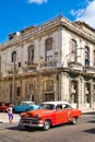 Vintage american car next to an crumbling old building in Havana Royalty Free Stock Photo