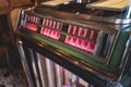 Vintage American music jukebox with illuminated buttons, process of choosing song composition, retro old-fashioned juke-box with