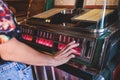 Vintage American music jukebox with illuminated buttons, process of choosing song composition, retro old-fashioned juke-box with