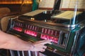 Vintage American music jukebox with illuminated buttons, process of choosing song composition, retro old-fashioned juke-box with