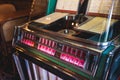 Vintage American music jukebox with illuminated buttons, process of choosing song composition, retro old-fashioned juke-box with