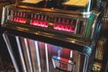 Vintage American music jukebox with illuminated buttons, process of choosing song composition, retro old-fashioned juke-box with