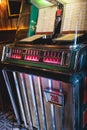 Vintage American music jukebox with illuminated buttons, process of choosing song composition, retro old-fashioned juke-box with