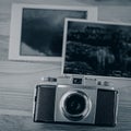 Vintage analog camera and old photographic prints Royalty Free Stock Photo