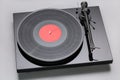 Turntable playing vinyl close up with needle on the record with grey background Royalty Free Stock Photo