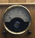 Vintage analogue ammeter made of metal on a wooden work bench Royalty Free Stock Photo