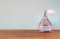 Vintage antigue perfume bottle, on wooden table