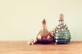 Vintage antigue perfume bottles, on wooden table. retro filtered image Royalty Free Stock Photo