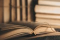 Vintage, antiquarian books pile on wooden table Royalty Free Stock Photo