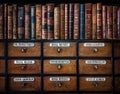 Vintage, antiquarian books on wooden old pharmaceutical cabinet. Retro medical and pharmaceutical background. Translation from Royalty Free Stock Photo