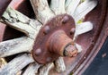 Vintage antique automotive tractor wood wheel spokes and hub covered in rust and oxidation