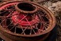 Vintage antique automotive wire wheel spokes and hub with red peeling paint and rust