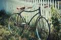 Antique bicycle leaning on a fence Royalty Free Stock Photo