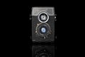 Vintage antique camera isolated on black glass Royalty Free Stock Photo