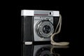 Vintage antique camera isolated on black glass Royalty Free Stock Photo