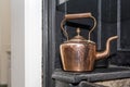 Vintage and antique copper kettle on a Victorian stove in a trad