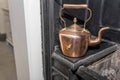 Vintage and antique copper kettle on a Victorian stove in a trad Royalty Free Stock Photo