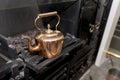 Vintage and antique copper kettle on a Victorian stove in a trad Royalty Free Stock Photo