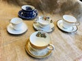 Vintage Antique Collection of Fine Bone China with Gold Trim and Flowers Teacup and Saucer on Burlap Background