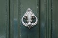Vintage antiqued door knocker on wooden green door Royalty Free Stock Photo