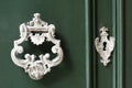 Vintage antiqued door knocker on wooden green door