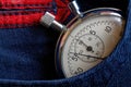 Vintage antiques Stopwatch, in dark blue jeans pocket, value measure time, old clock arrow minute, second accuracy timer record