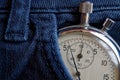 Vintage antiques Stopwatch, in dark blue denim pocket, value measure time, old clock arrow minute, second accuracy timer record