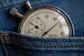 Vintage antiques Stopwatch, in old dark blue denim pocket, value measure time, old clock arrow minute, second accuracy timer recor Royalty Free Stock Photo