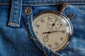 Vintage antiques Stopwatch, in old worn dark blue denim pocket, value measure time, old clock arrow minute, second accuracy timer Royalty Free Stock Photo
