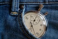 Vintage antiques Stopwatch, in old worn dark blue jeans pocket, value measure time, old clock arrow minute, second accuracy timer Royalty Free Stock Photo