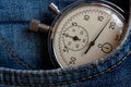 Vintage antiques Stopwatch, in old worn dark blue denim pocket, value measure time, old clock arrow minute, second accuracy timer Royalty Free Stock Photo