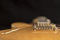 Vintage archtop guitar in natural maple close-up high angle view on black background, golden hardware detail in selective focus Royalty Free Stock Photo