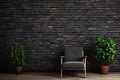 Vintage armchair with house plants against black brick wall. Loft studio. Copy space