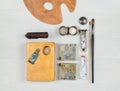 Layout of vintage tools of the artist or restorer. The old palette, tubes and brushes. Top view