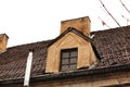Vintage attic window on red tile roof with chimney Royalty Free Stock Photo