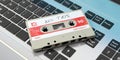 Vintage audio cassette, text mix tape on the label, on a laptop. 3d illustration Royalty Free Stock Photo