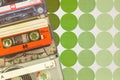 Vintage audio compact cassettes in front of seventies retro wallpaper