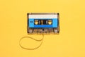 Vintage audio tape with unwound spool over yellow Royalty Free Stock Photo