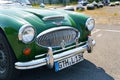 Vintage Austin Healey 3000. Front view of the hood, grille, chrome bumper and headlights.