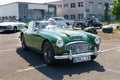 A vintage Austin Healey 3000 stands in the parking lot in front of the Burgenland classic.