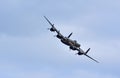 Vintage Avro Lancaster world war 2 bomber with wheels down in flight.