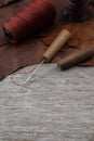 Awl with wooden handle and nylon thread placed on leather and old wooden floors. Royalty Free Stock Photo