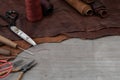 Awl with wooden handle and nylon thread placed on leather and old wooden floors. Royalty Free Stock Photo